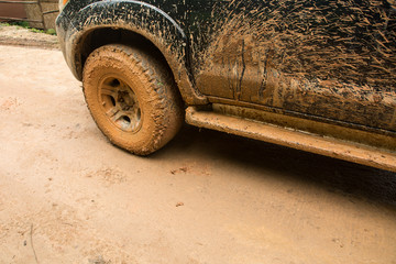 Closeup dirty Wheels in a countryside, Adventure background. Detail of dirty off-road car, Dirty offroad car side © 9kwan
