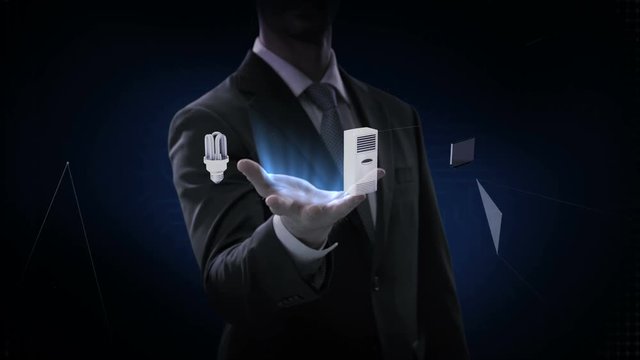 Businessman opens palm, '4th Industrial Revolution' connecting monitor, microwave, light bulb, washer, air conditioner, audio, coffee pot,  smart Home Appliances, 4k movie.