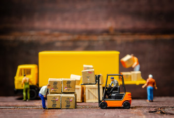 miniature warehouse workers forklift carrying goods box to semi truck with trailer .logistics...
