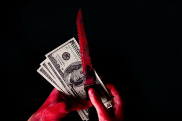 hungred dollar bills in blood on dark background
