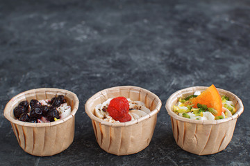 Gourmet food Snack Tartlet Creamy goat cheese Dried Fruit Appetizer Dark concrete background Copy space French cuisine