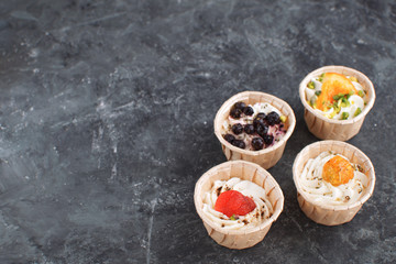 Gourmet food Snack Tartlet Creamy goat cheese Dried Fruit Appetizer Dark concrete background Copy space French cuisine