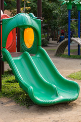 Green slider tunnel in park.