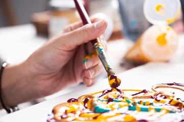 Close up of a female hand painting