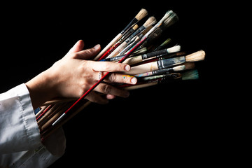 hand woman holding paint brushes