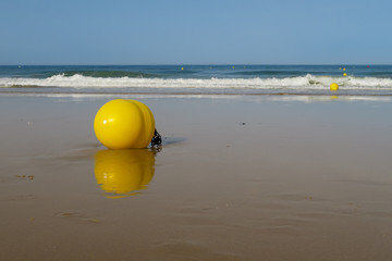 Maritime signaling buoys at La Barrosa beach in Sancti Petri, Spain