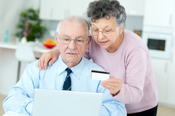 senior couple buying on internet with credit card