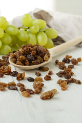 a bunch of grapes and raisins on a white background