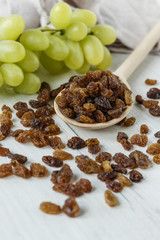 a bunch of grapes and raisins on a white background