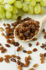 a bunch of grapes and raisins on a white background