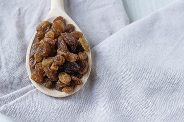 raisins in a wooden spoon