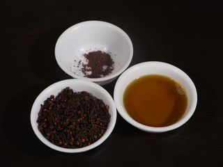 dry cloves on white background,Clove,Clove Powder,Mustard Oil,Mustard Oil and Clove on Wooden background, Mustard oil and Clove in White Bowl