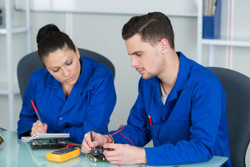 handsome happy computer engineers repairing open computer