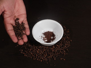 dry cloves on white background, Clove in hand and Wooden Background, Clove