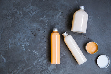 Natural spa cosmetics on a dark blue beton concrete background. Beauty blogger, minimalism concept, copy space