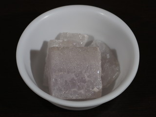 A lump of alum crystal. Alum is a very good chemical compound that is used as a medicine and for beauty treatment. Fitkari