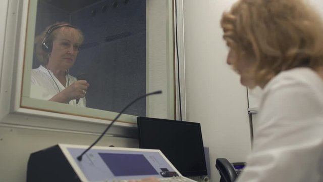 Doctor checks the hearing with equipment