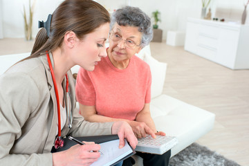 doctor visiting and elderly woman at her house