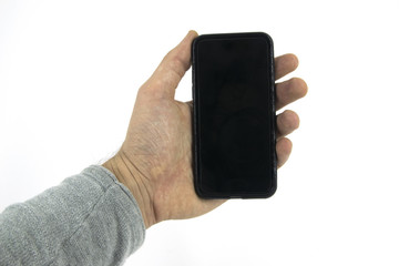 Studio shot of hand holding mobile phone device