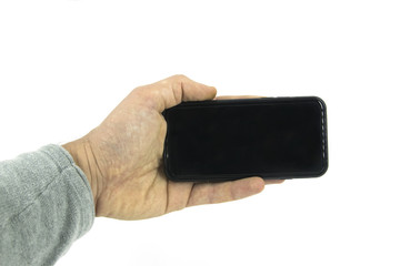 Studio shot of hand holding mobile phone device