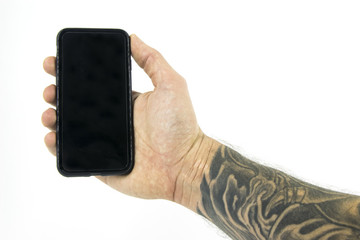 Studio shot with a hand holding a device with forearm tattooed