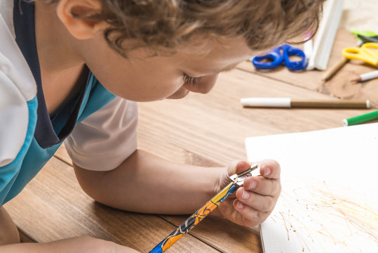 Child Sharpening A Pencil.