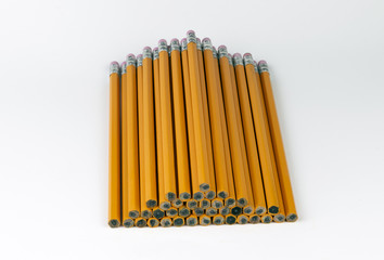 Orange, unsharpend pencils neatly stacked in a pyramid