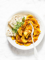 Zucchini curry on a light background, top view. Vegetarian healthy lunch