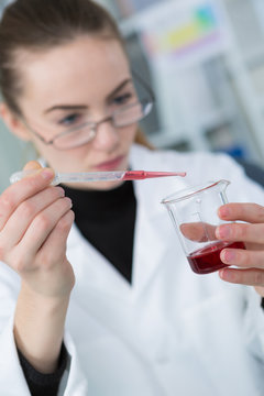 young woman scientist working in the lab with blood