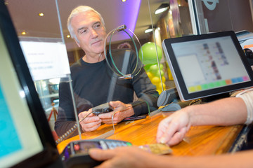 man paying in the window counter