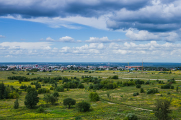Fototapeta na wymiar The old abandoned airport is overgrown with trees and grass. Landscape outskirts of the city