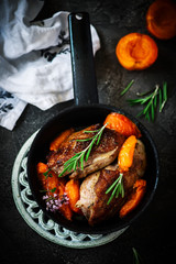 Duck breast with apricots . dark photo .style vintage