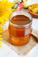 Honey in a glass jar, honeycomb, pollen. Products of beekeeping. The concept of healthy eating. Honey theme.