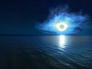 Beautiful magic blue night starry sky with clouds and full moon with reflexion of moonlight in the...