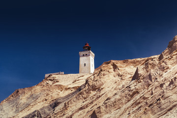 Fototapeta na wymiar Famous lighthouse on the top of the sand dune cliffs in Northern Denmark. Rubjerg Knude Lighthouse, Lønstrup in North Jutland in Denmark, Skagerrak, North Sea