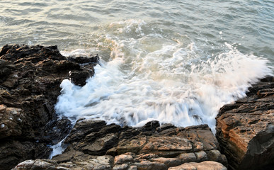 Sea surf splashing with rock at sea
