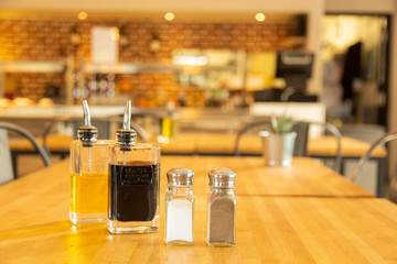 Pepper shaker and salt shaker with bottles of vinegar and oil