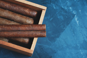 Cigars, Guillotine cuts off the cigar tip, black background , space for text, copy space.