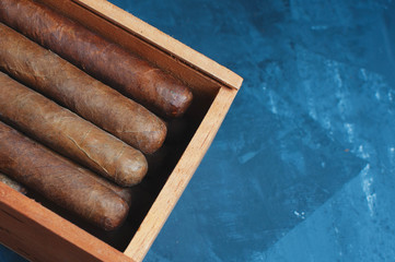 Cigars, Guillotine cuts off the cigar tip, black background , space for text, copy space.