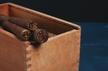 Cigars, Guillotine cuts off the cigar tip, black background , space for text, copy space.