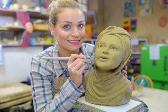 Artist making finishing touches to bust