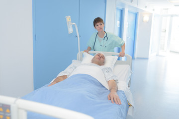 nurse transferring the patient to the recovery room