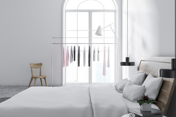 White bedroom interior, clothes rack side view