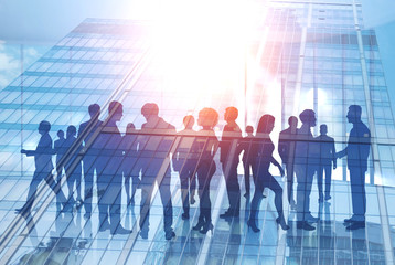 Business people silhouettes in morning city