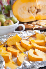 Sliced pumpkin before baking on a sheet of foil