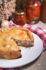 Autumn chicken pie with potatoes and canned tomatoes in the background