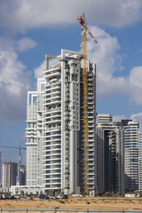 Fototapeta na wymiar Construction of a skyscraper with a crane