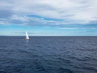 Fototapeta premium Sailing Boat in the sea with bright blue sky