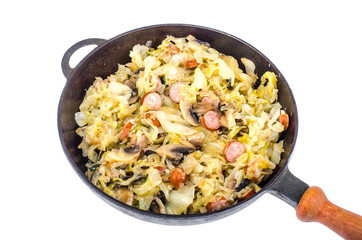 Frying pan with fried cabbage, sausages and mushrooms on white background