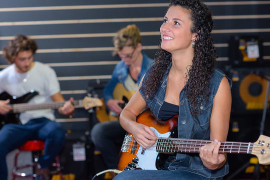 Young lady playing electric guitar